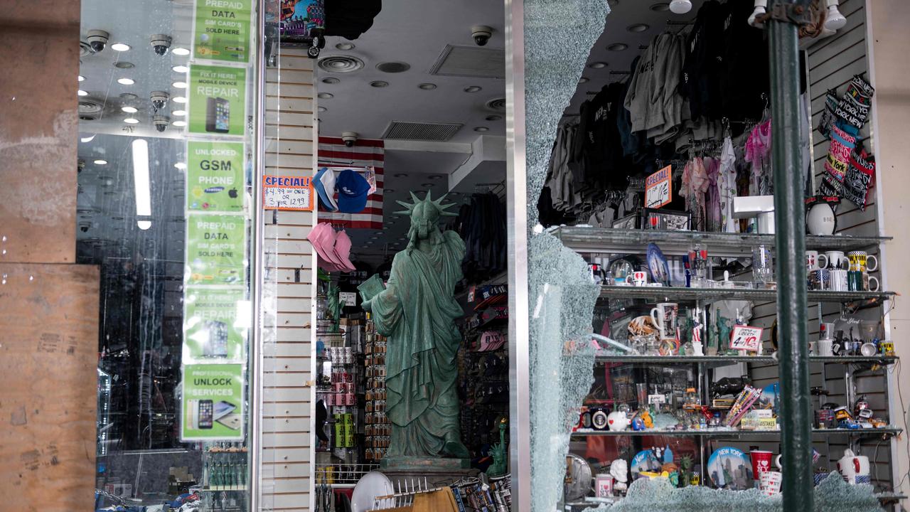 A replica Statue of Liberty inside a smashed store. Picture: Johannes Eisele / AFP