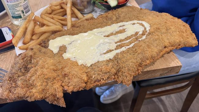 Jayme Carr’s beef schnitzel from Maracello Cafe was so large it touched the table – and fed three people. Picture: Facebook.