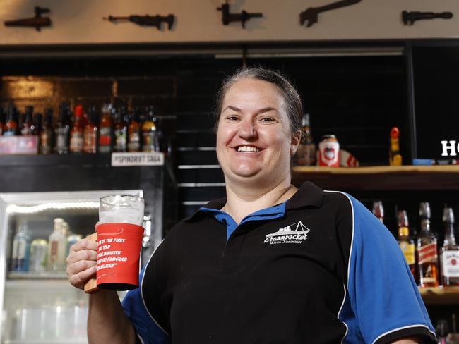 DAILY TELEGRAPH MAY 10, 2022. EMBARGOED UNTILL 16TH MAY FOR THE DAILY TELEGRAPH, PLEASE CONTACT PIC EDITOR NICOLA AMOROS BEFORE PUBLISHING. Mellisa Alvey and her husband  Joel own the Steampacket Hotel Nelligen in the Federal electorate of Gilmore. Pictured with their stubby holders with the quote from local firefighter Paul Parker who told the PM where to go after the black summer bushfires. Paul acquired a bar tab over $3000 when people came from all over wanting to have a beer with him. Picture: Jonathan Ng