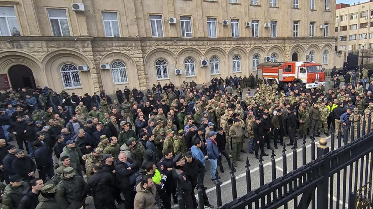 Demonstrators gathered outside the parliament building of Abkhazia as tensions flared over a proposed pact that would encourage Russian investment in the region. Picture: Aiashara Independent Agency via AP.