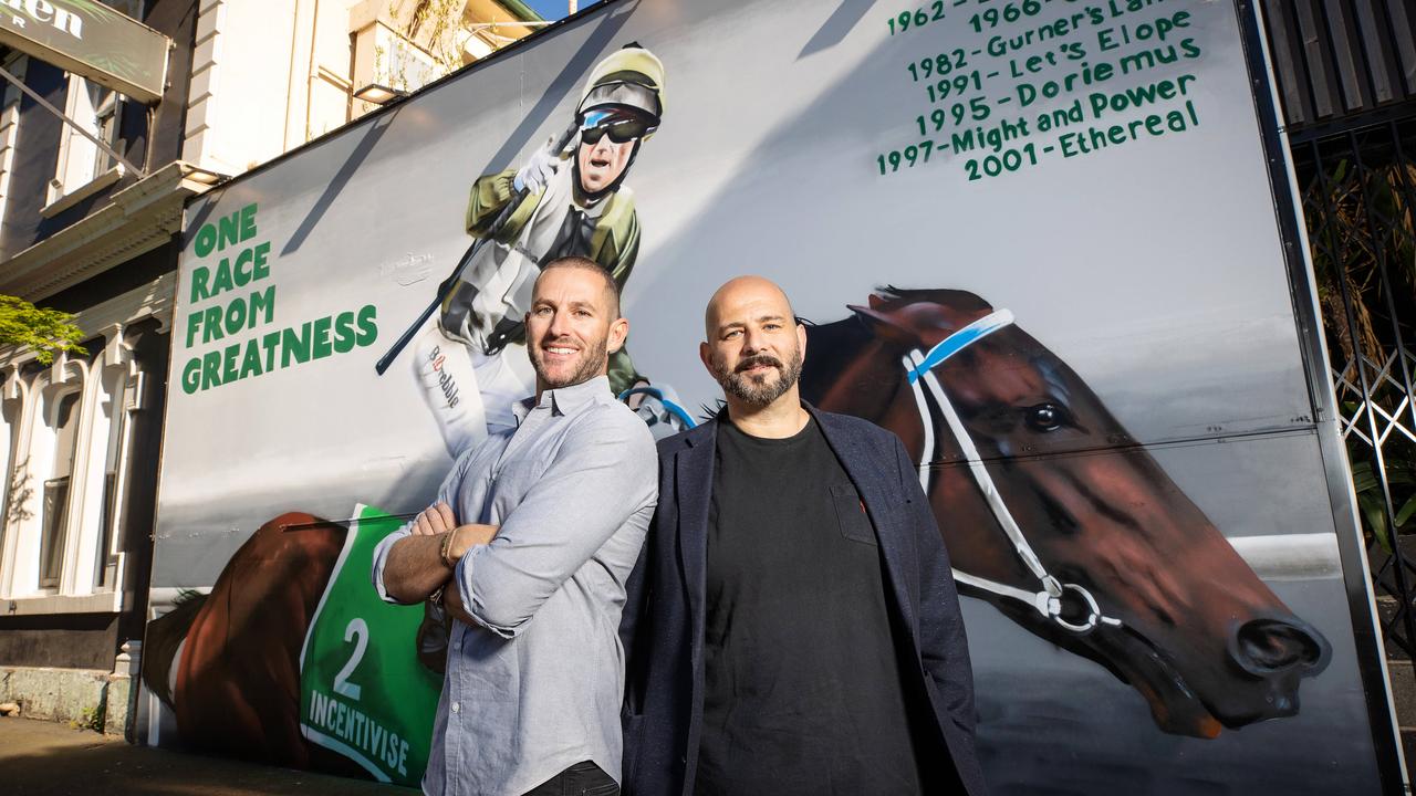 Incentivise owners Brae Sokolski and Ozzie Kheir (jacket and black T-shirt) unveil a large scale mural of Incentivise at the Bells Hotel