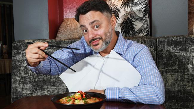 Gino Luglietti who sees himself as the Laksa Legend slurps away at his favourite laksa place Rendezvous Cafe in the CBD. Picture Katrina Bridgeford.