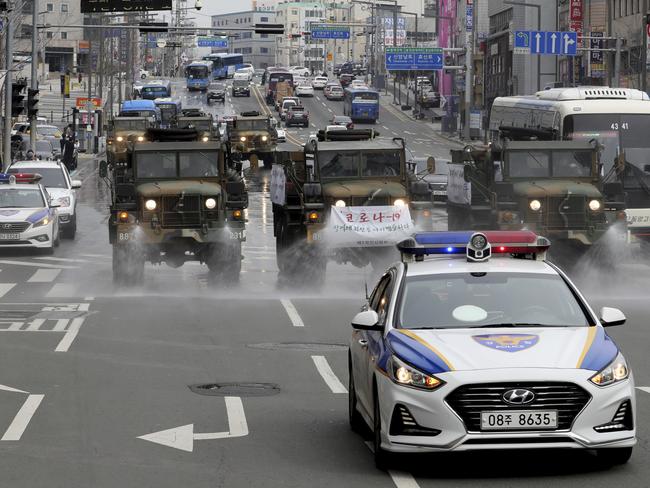 Military trucks spray disinfectant to prevent the spread of a new coronavirus outside the Dongdaegu train station in Daegu, South Korea.