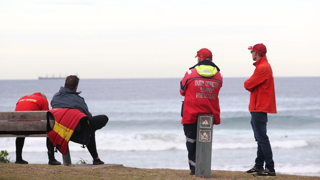 Rescue personnel keep an eye on the coastline for the 62-year-old rock fisherman on Tuesday. Picture: Peter Lorimer