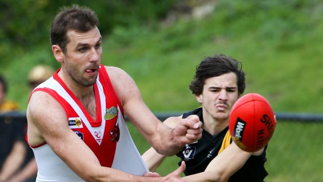 Karingal champion Luke Van Raay gets a handball away against Seaford last season. Picture: David Trend