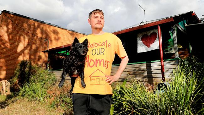 Harper Dalton with his dog Lemon show off the damage to his home after the extreme floods earlier this year. Picture: NCA NewsWire/ Scott Powick