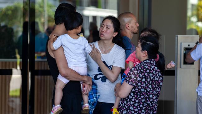 Frustrated residents outside the Opal Tower after learning they will be forced out. Picture: Jordan Shields