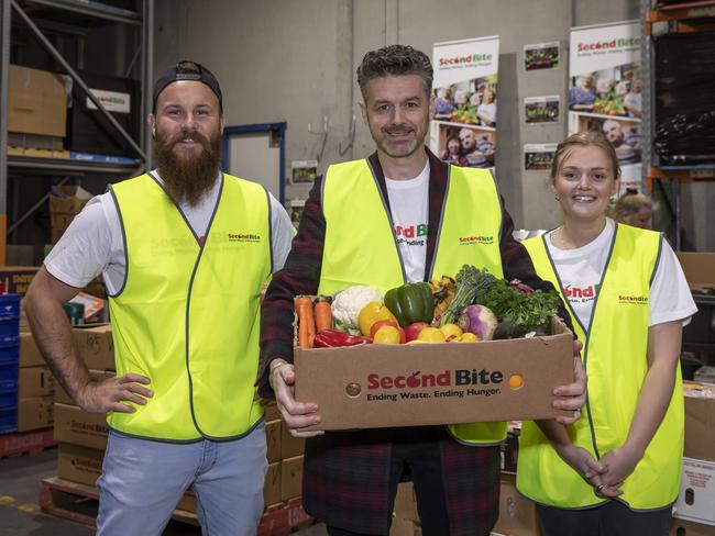 MasterChef contestants Brent Draper and Sabina Newton with judge Jock Zonfrillo with produce ready to be dispatched from SecondBite. Picture: Supplied