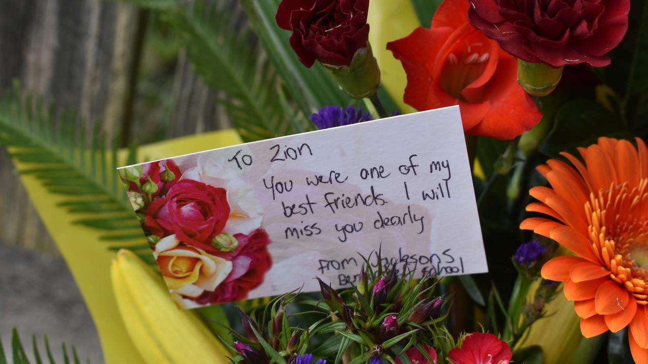 A heartbreaking message to Zion from a school friend, placed in flowers on the driveway.