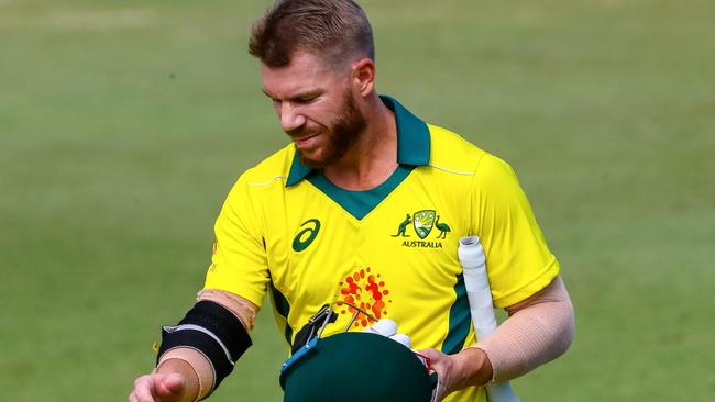 Australia's David Warner walks off the ground after he was dismissed during a World Cup cricket warm-up match