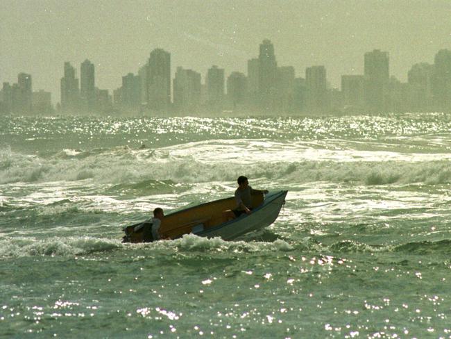 1999: Boys having fun in their dinghy near the bar at Currumbin.