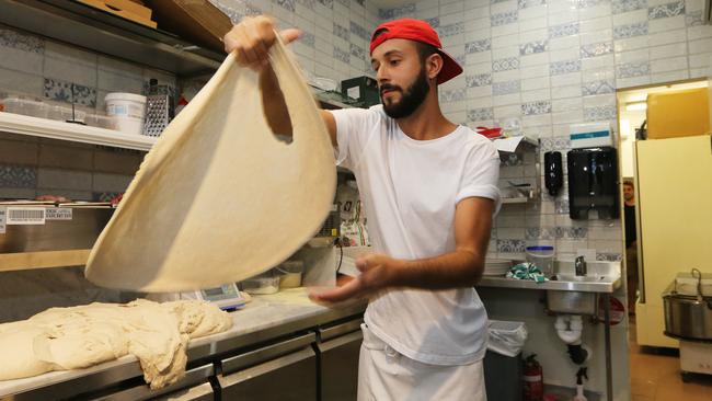 Pizza maker Flavio Giannino shows his style. Picture: Glenn Hampson