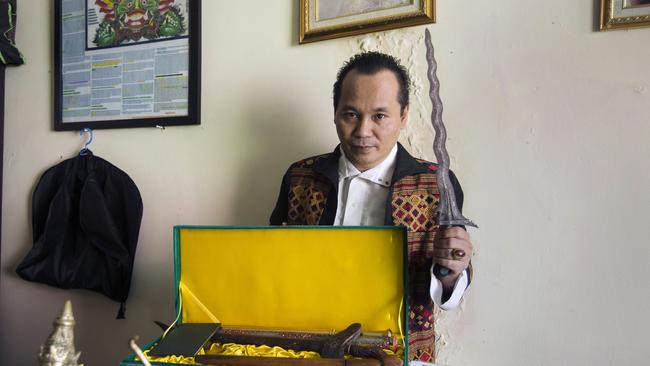 Money cult leader Sino Soegihartonotonegoro with <i>keris</i> sacred daggers in his Cirebon home, which is filled with mystic statuary and mysterious oils. Picture: Ed Wray