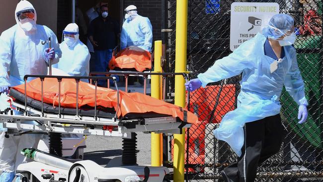 Medical staff move bodies from the Wyckoff Heights Medical Center to a refrigerated truck in New York. Picture: AFP.