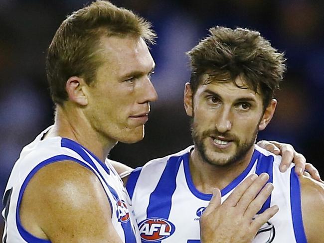 AFL Round 2. North Melbourne vs Brisbane Lions at Etihad Stadium. Drew Petrie congratulates Jarrad Waite after goal number 7 . Pic: Michael Klein. Sunday April 12, 2014.