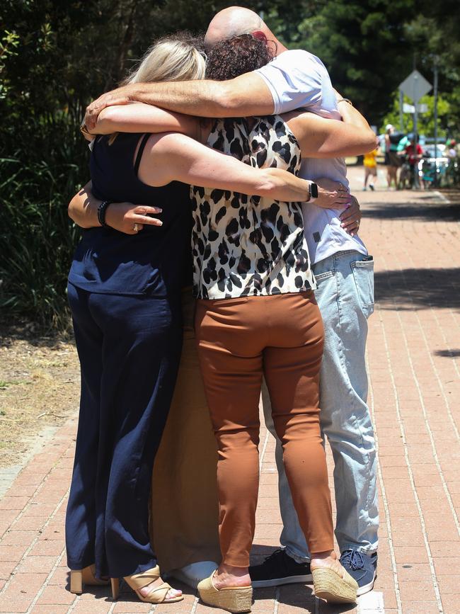 The siblings sharing a group hug. Picture: Gaye Gerard