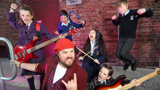 The cast announcement of School of Rock musical at Her Majesty's Theatre in Melbourne. Remy Grunden, 10 (girl guitar), Ethan Stephenson, 12 (head tie), Stephanie Kipnis, 10 (drum sticks), Caleb Elbourne, 10 (jumping), and Hudson Sharp, 12 (guitar). Brent Hill plays Jack Black's character 'Dewey'. Picture: Alex Coppel.