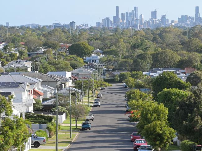 Brisbane - Nov 18 2023:Residential houses street against Brisbane City skyline.Home prices across Australia have hit new highs, with the median value of a home in a capital city shooting to $832,000. housing suburbs generic