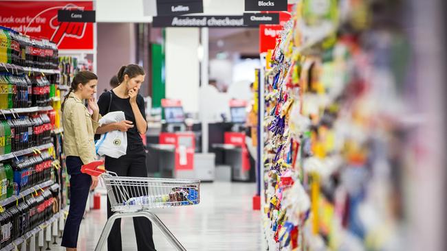 Shoppers browse in an aisle inside a Coles supermarket, operated by Wesfarmers Ltd., in Sydney, Australia, on Tuesday, Feb. 18, 2014. Wesfarmers, Australia's largest employer, is scheduled to report first-half earnings on Feb. 19. Photographer: Ian Waldie/Bloomberg via Getty Images