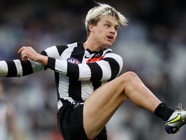 MELBOURNE, AUSTRALIA - JUNE 26: Jack Ginnivan of the Magpies kicks the ball during the 2022 AFL Round 15 match between the Collingwood Magpies and the GWS Giants at the Melbourne Cricket Ground on June 26, 2022 in Melbourne Australia. (Photo by Michael Willson/AFL Photos via Getty Images)