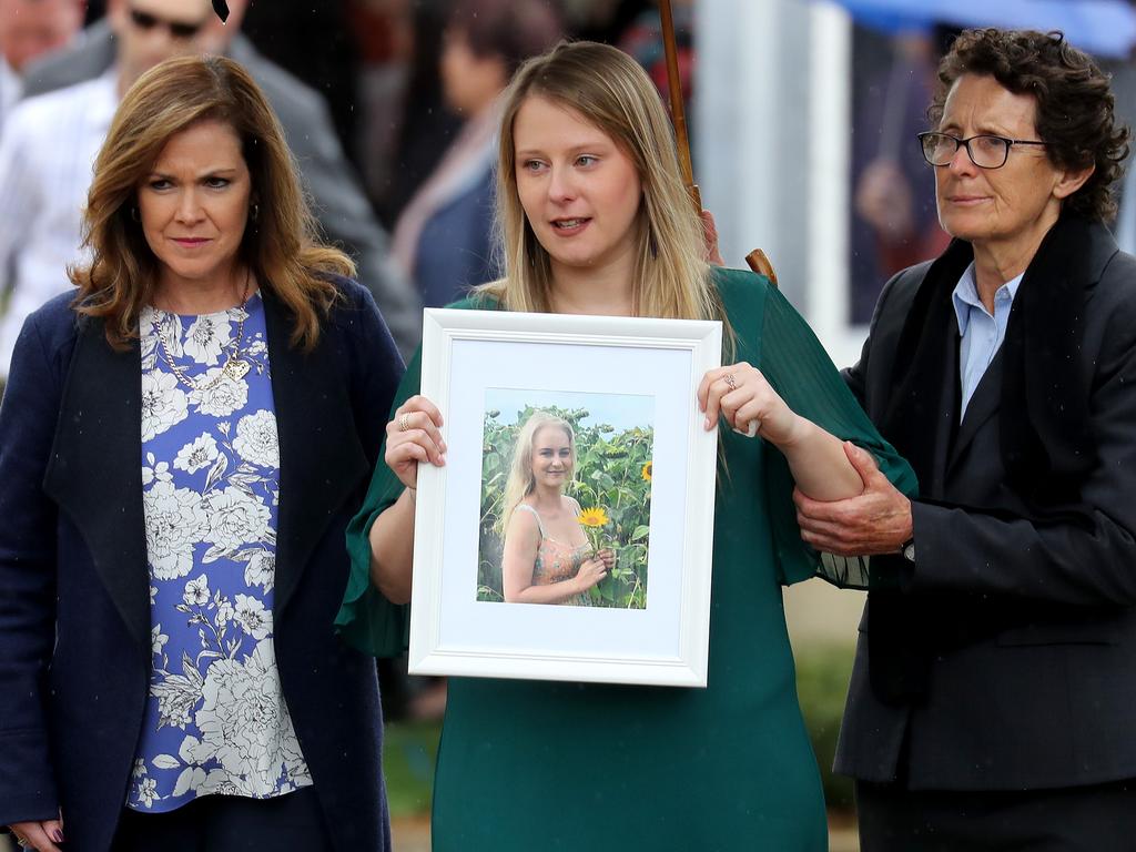 Emily Dunn carries a photo of her sister. Picture: Toby Zerna