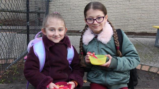 Mill Park Heights Primary School pupils Jood and Janna have a meal at the breakfast club.