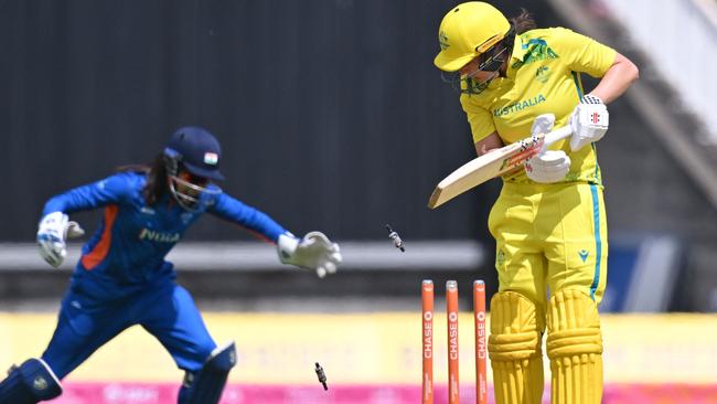 Australia's Tahlia McGrath is dismissed by India's Renuka Singh Thakur. Photo by Glyn KIRK / AFP