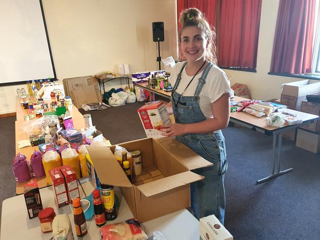 Community Case Worker Ianna Murray packing up some food boxes for delivery to those in need.