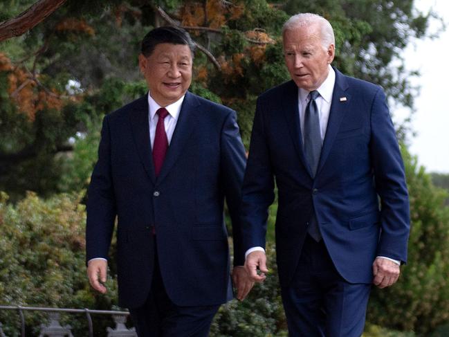 US President Joe Biden (R) and Chinese President Xi Jinping walk together after a meeting during the Asia-Pacific Economic Cooperation (APEC) Leaders' week in Woodside, California on November 15, 2023. Biden and Xi will try to prevent the superpowers' rivalry spilling into conflict when they meet for the first time in a year at a high-stakes summit in San Francisco on Wednesday. With tensions soaring over issues including Taiwan, sanctions and trade, the leaders of the world's largest economies are expected to hold at least three hours of talks at the Filoli country estate on the city's outskirts. (Photo by Brendan Smialowski / AFP)