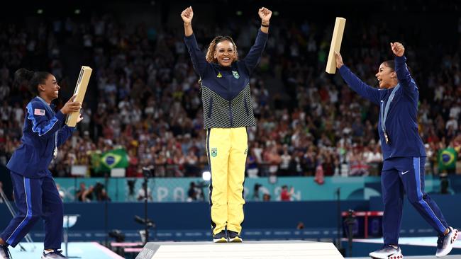 The trio celebrated on the podium. (Photo by Naomi Baker/Getty Images)