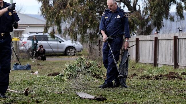 Tasmania Police search for bullet casings in the field in East Street, Campbell Town, adjacent to the residence where Shane Barker was murdered in 2007 Picture: LUKE BOWDEN