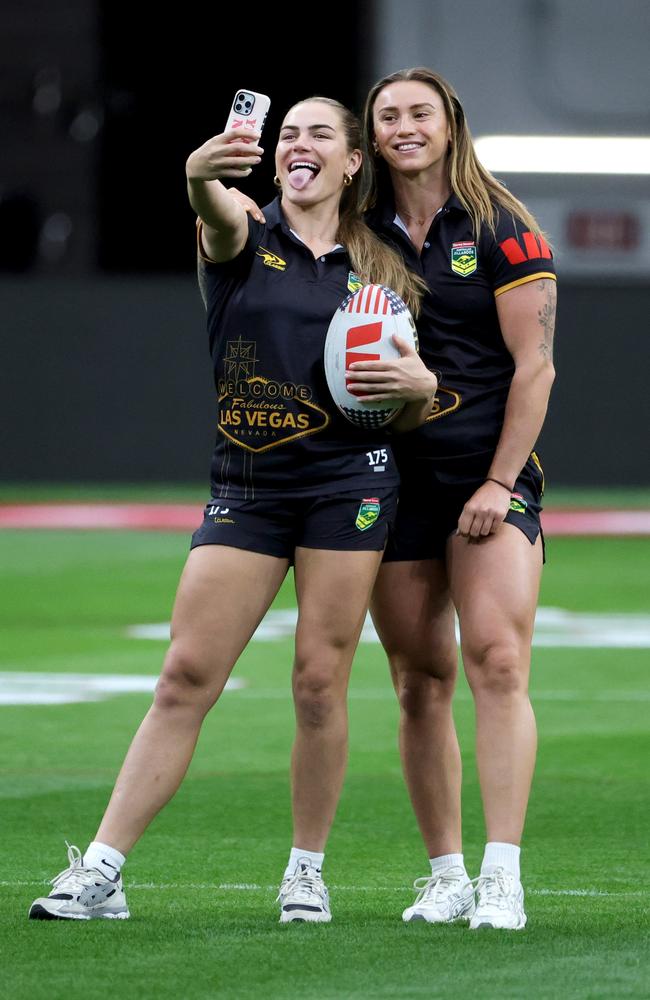 Jakiya Whitfeld (L) and Julia Robinson of the Australian Jillaroos take selfies on the pitch during an NRL team Captain's Run at Allegiant Stadium on February 28, 2025 in Las Vegas, Nevada. (Photo by Ethan Miller/Getty Images)