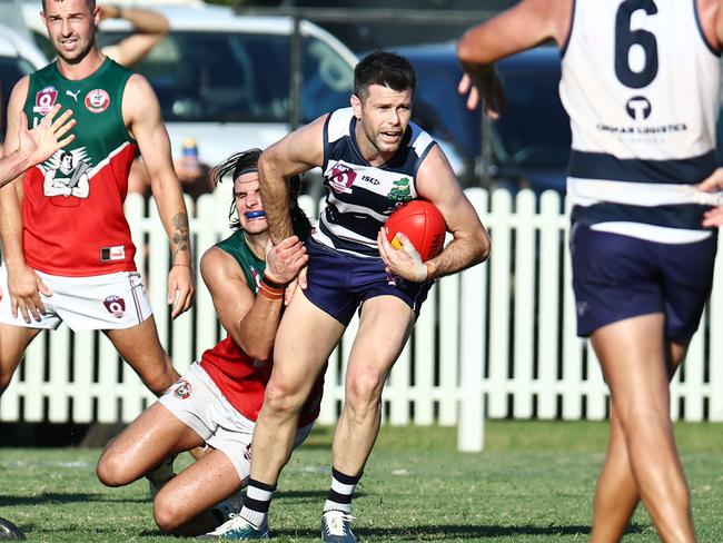 Three time AFL premiership winning captain Trent Cotchin is tackled in the AFL Cairns Pride Round clash between the Port Douglas Crocs and the South Cairns Cutters at Port Douglas. Picture: Brendan Radke