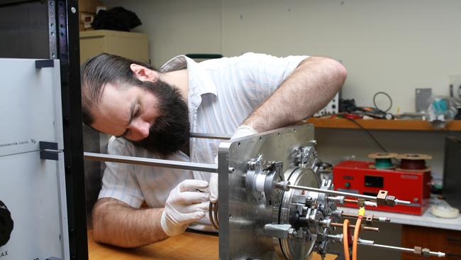 Patrick Neumann with the satellite’s cathode-anode-coil array. Picture: Horst Burkhardt.