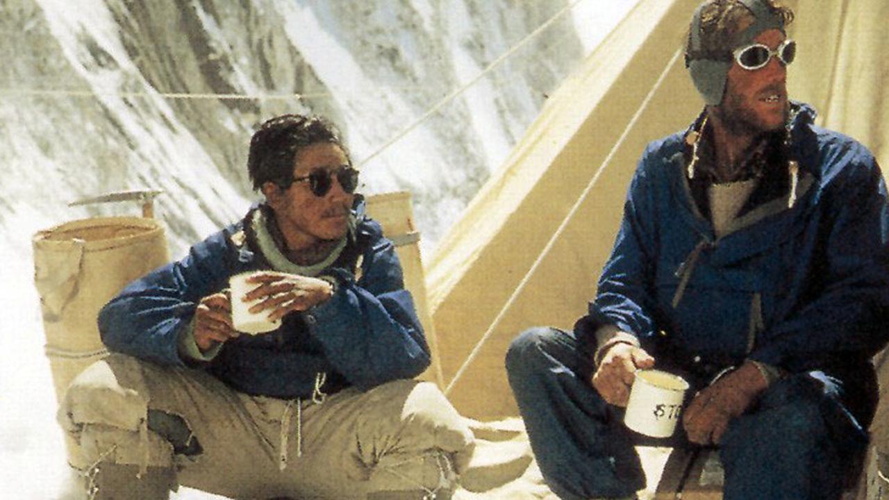 Explorers Tenzing Norgay and Sir Edmund Hillary enjoy a warm drink on the mountain. Picture: AP