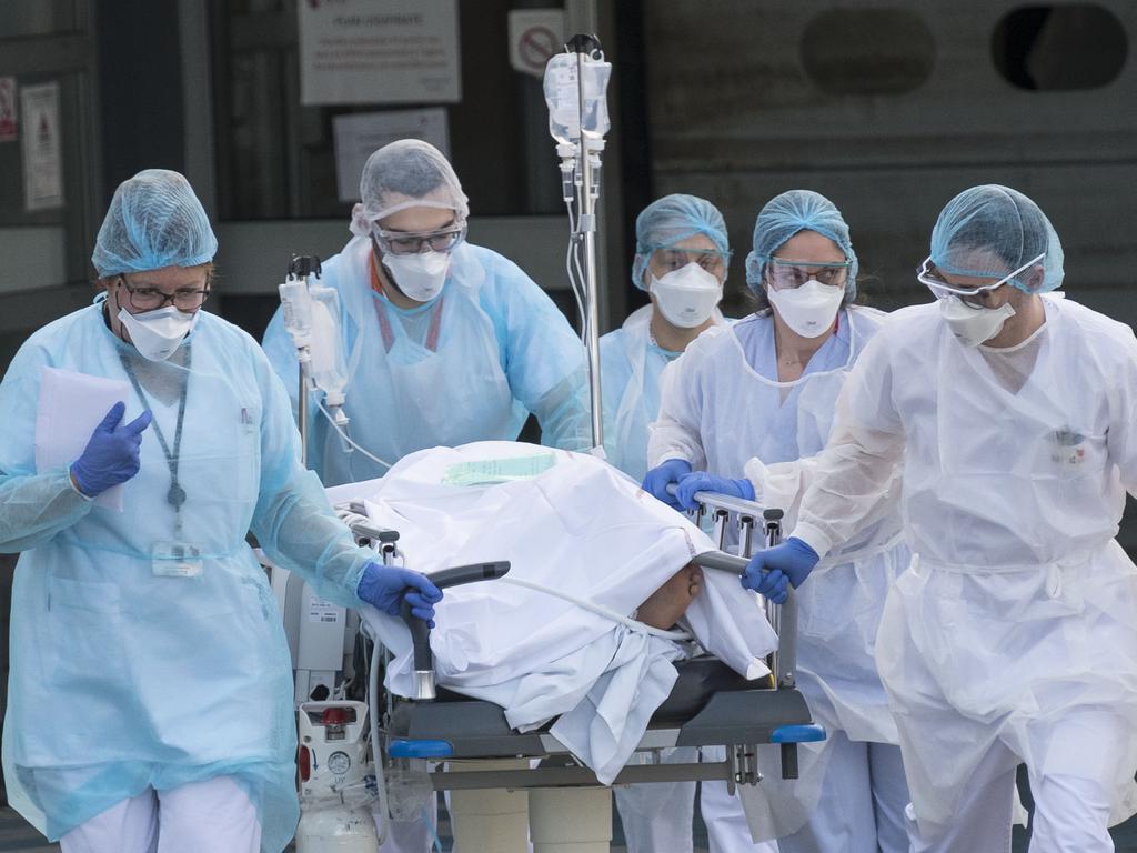 French medical staff push a patient on a gurney to a waiting medical helicopter amid the coronavirus outbreak. Picture: AFP