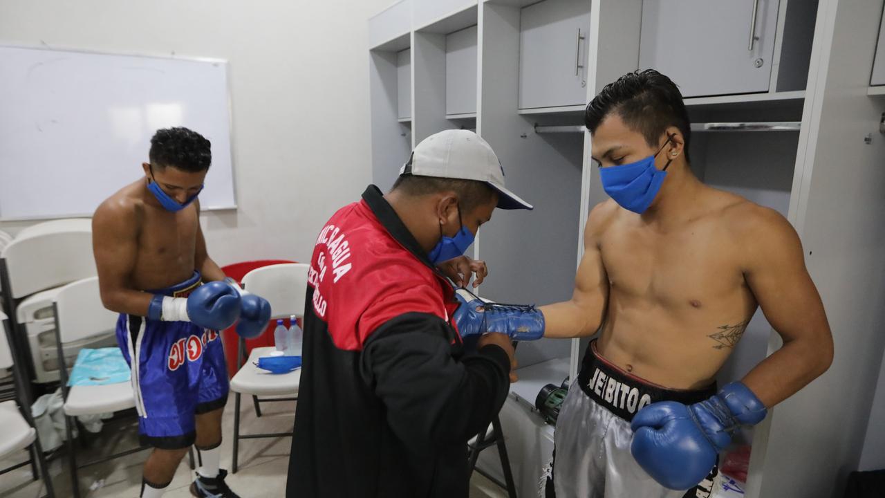 Nicaraguan Boxers wearing face masks get ready in the locker rooms. (Photo by Getty Images/Getty Images)