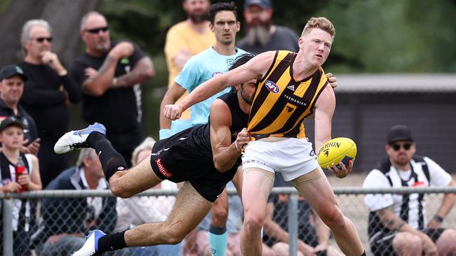 MELBOURNE. 25/02/2022. AFL. Collingwood vs Hawthorn at Morwell Recreational Reserve, Morwell. James Sicily of the Hawks tackled by Brodie Grundy of the Magpies. Photo by Michael Klein