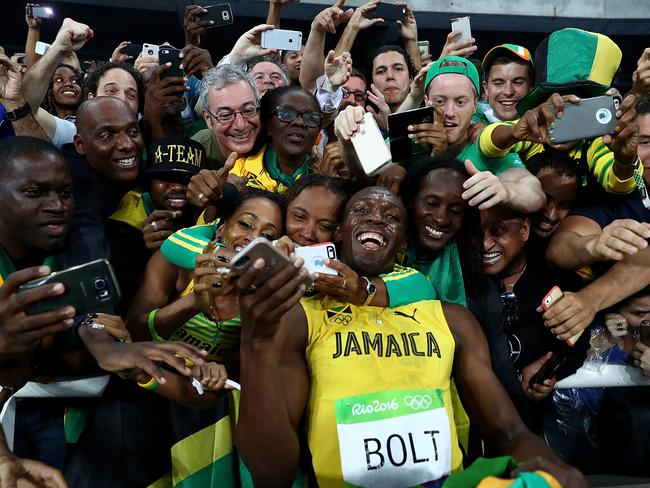 Usain Bolt of Jamaica celebrates with fans after winning the Men's 200m Final