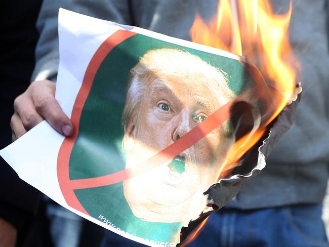 A Palestinian protester burns an image of US President Donal Trump. Picture: AFP