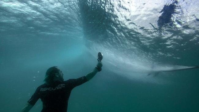 Mitch Gilmore snapped this photo of a fellow ocean photographer taking pics of a surfer riding a wave.