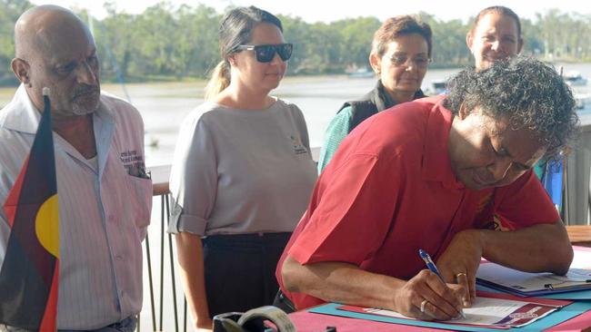 Bidgerdii Community Health Services' CEO Thalep Ahmat signs the Statement of Cooperation. Picture: Jann Houley