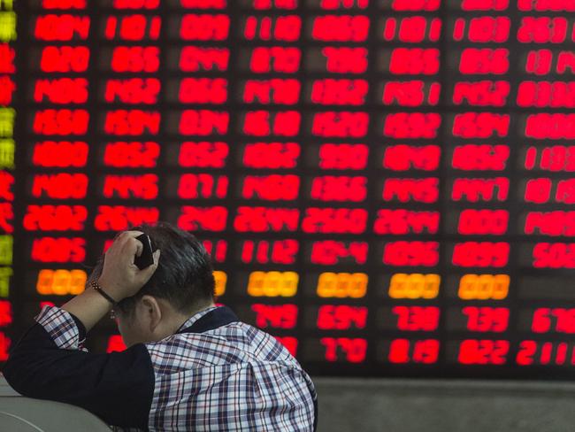 A man stands in front of an electronic board displaying share prices at a securities exchange house in Shanghai, China, on Friday, Sept. 18, 2015. China's stocks headed for the steepest weekly loss this month in shrinking turnover amid growing concern government measures to support the world's second-largest equity market and economy are failing. Photographer: Qilai Shen/Bloomberg