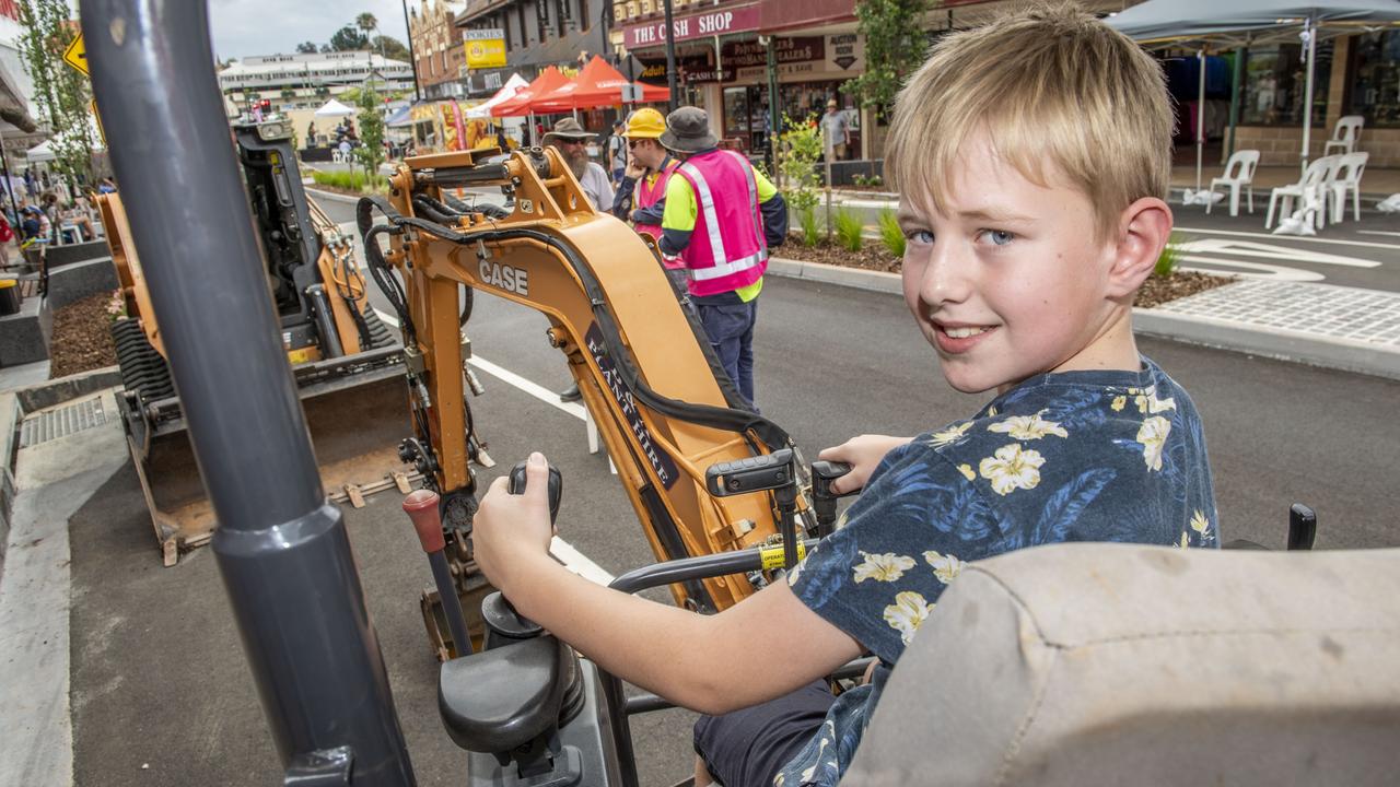 Aidan O'Hara tries out a digger at the Russell Street Refresh block party. Saturday, November 20, 2021. Picture: Nev Madsen.