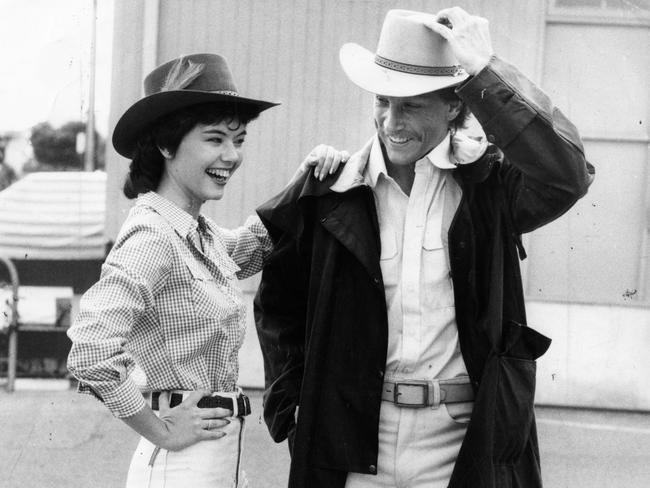 Vicki Monserrat and John Ziemek wearing bush fashions from R.M. Williams, including Akubra hats, boots and a Driza-Bone jacket, in 1984.