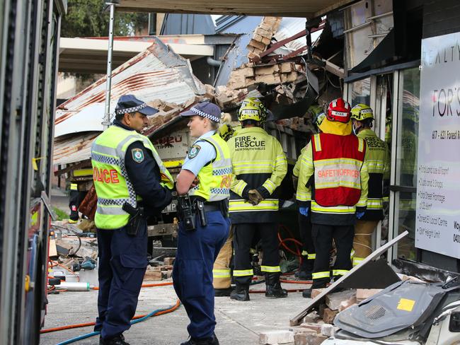 SYDNEY, AUSTRALIA - NewsWire Photos - MAY 21, 2024: A view of a truck crash in Bexley, Emergency crews, including firefighters, on the scene working hard to remove the driver who was trapped in the vehicle under rubble as the roof came down. The driver now in a stable condition taken to hospital. Picture: NewsWire / Gaye Gerard