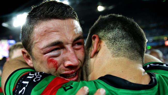 Sam Burgess hugs Greg Inglis after winning the 2014 Grand Final in which he was awarded the Clive Churchill Medal.