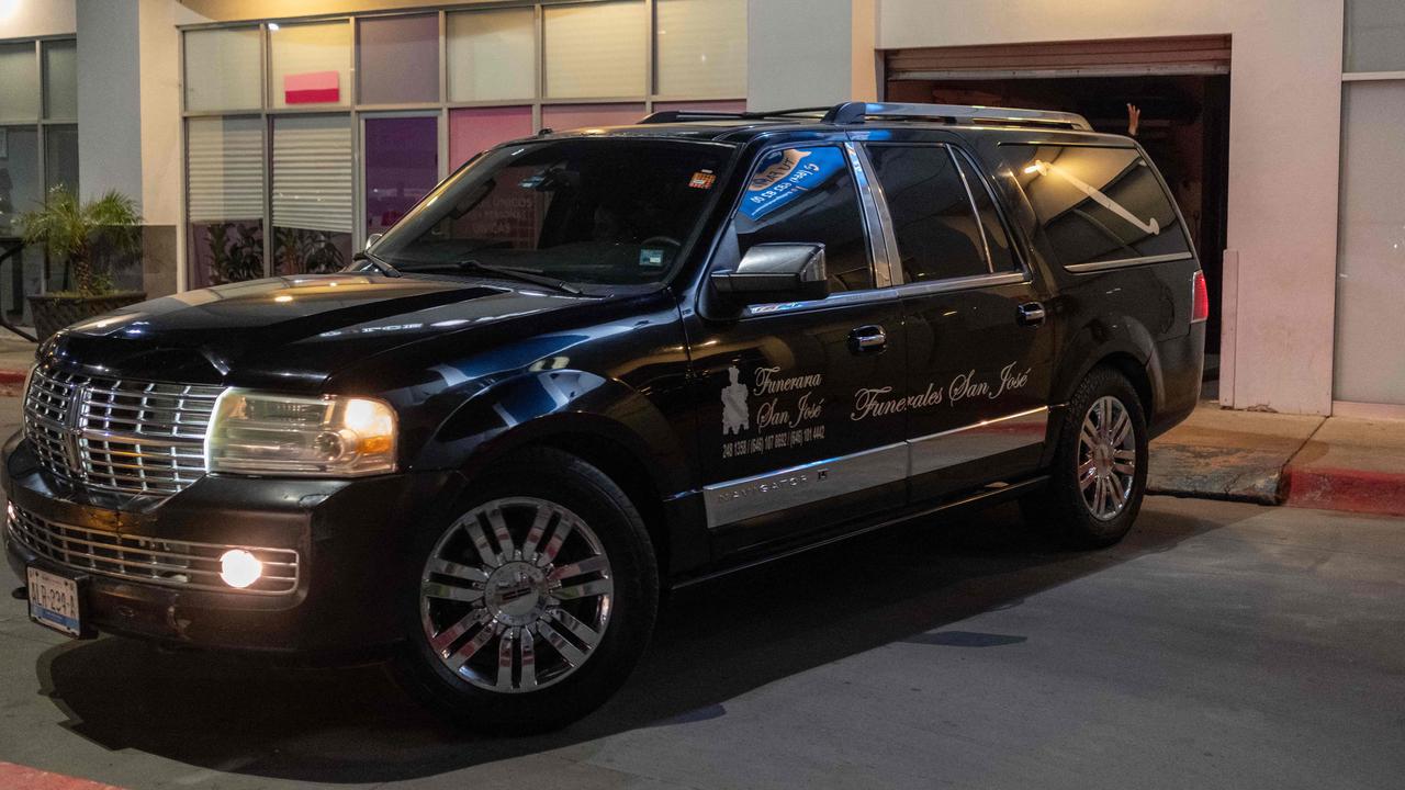A hearse from San Jose Mortuary transporting the bodies. Picture: Guillermo Arias / AFP