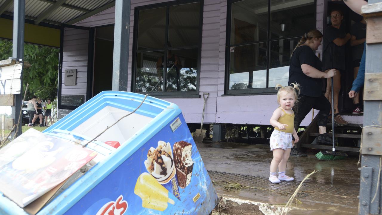 Young Florence Farr inspects the damage as her family cleans up the mess after the water receded.