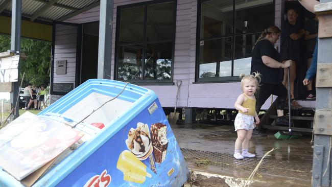 Young Florence Farr inspects the damage as her family cleans up the mess after the water receded.